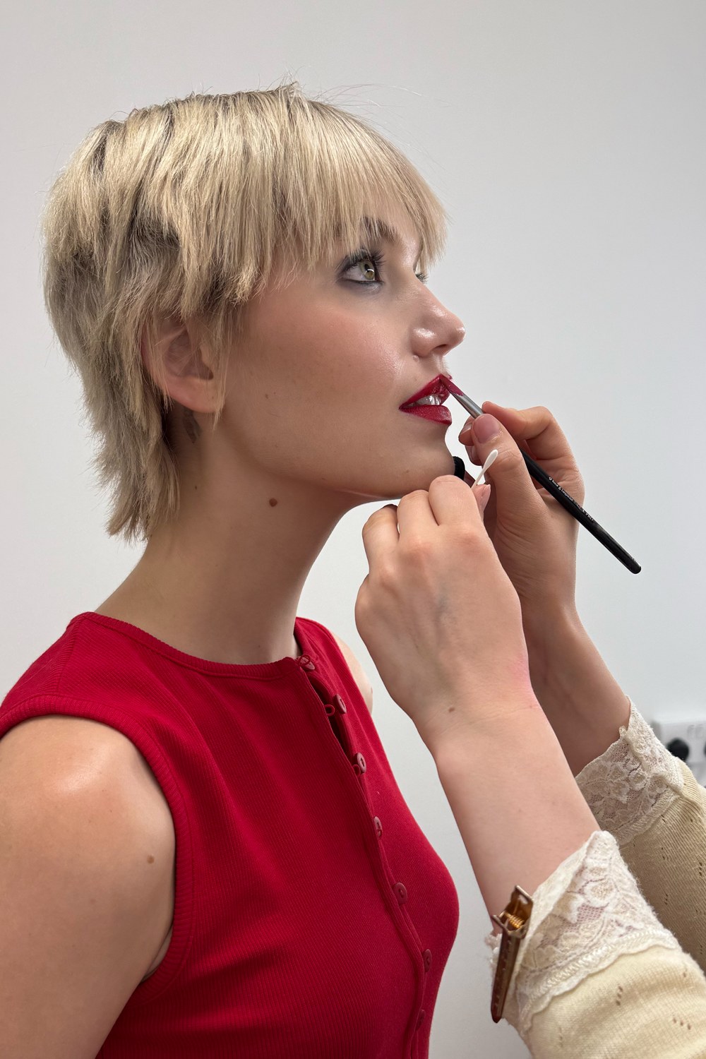 Behind the scenes, touching up makeup on set