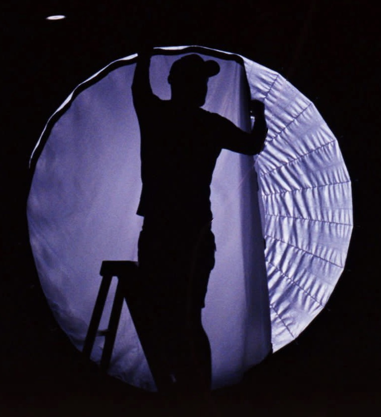 Behind the scenes, adjusting studio lighting