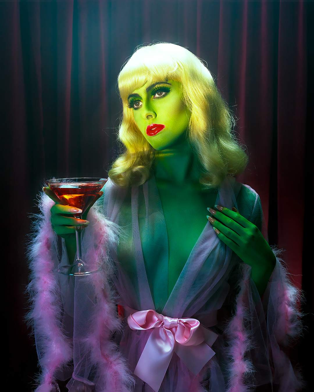 Editorial portrait, green lighting with martini glass
